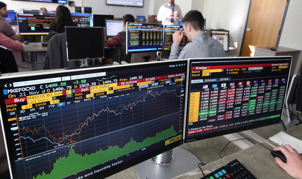 BSU students sitting at Bloomberg terminals in classroom with teacher at front of the classroom