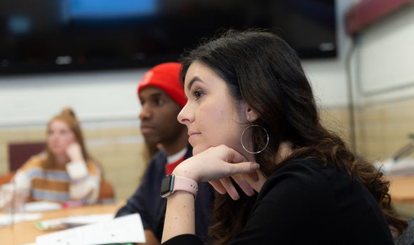 students sitting around a table in a classroom