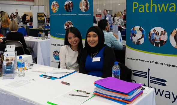 Two women at a career fair booth