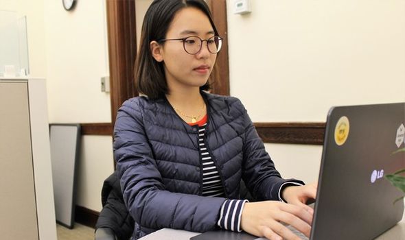 A BSU student sitting at a desk working on her computer