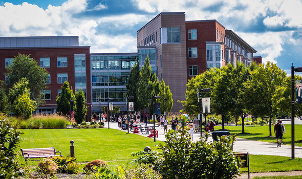 Students trekking across East Campus on a sunny day