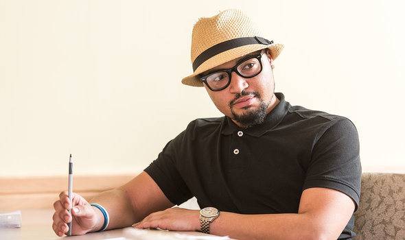 A student holding a pen, listening attentively