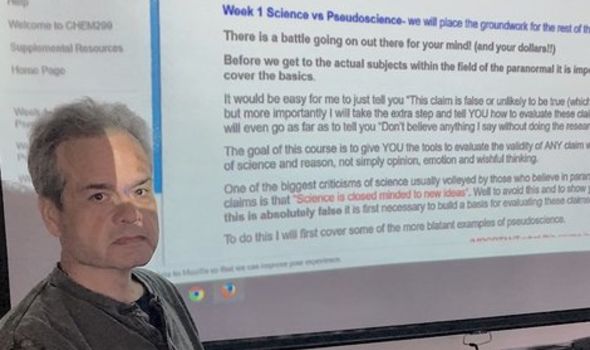 Joseph Keen stands in front of a projection of his syllabus