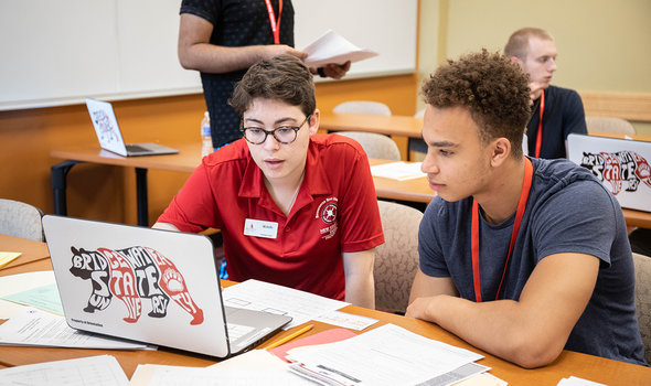 An orientation leader helps a new student