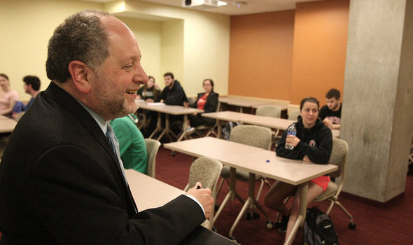 Dr. Aeon Skoble smiling at a podium in Philosophy class