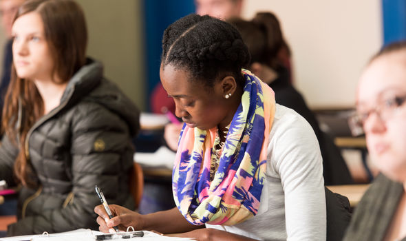 A student takes careful notes in philosophy class
