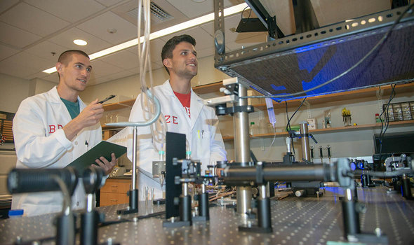 Two BSU students running a demo in the physics lab