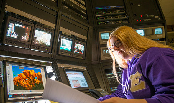 A BSU student sits in front of a bank of video monitors