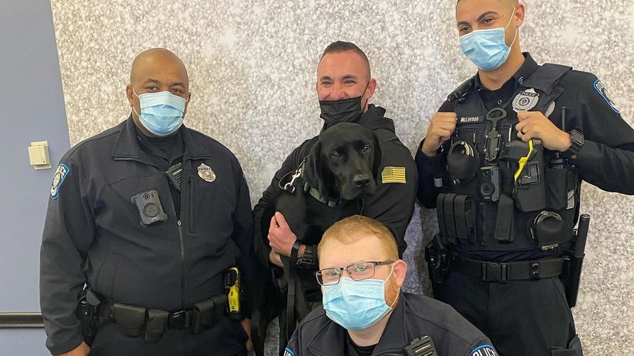 Zach being held by Captain Tepper and standing with patrol officers.