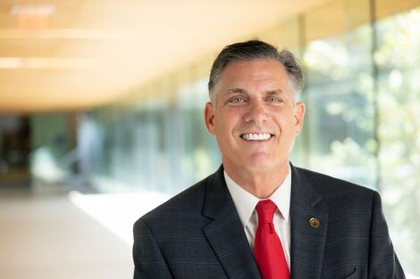 President Clark stands in a long hallway.