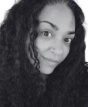 black and white headshot of Eman Abdalla with long curly black hair