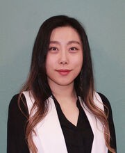 Dr. Hannarae Lee smiling with long straight dark hair and wearing a black and white blouse