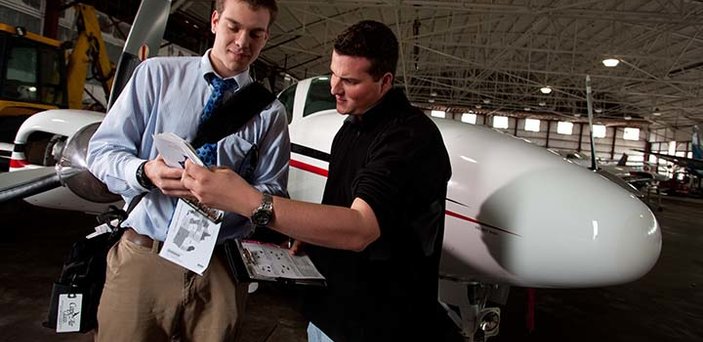 An aviation student and instructor go over last minute instrutions An aviation student and instructor go over last minute instrutions