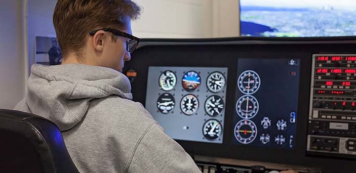 Aviation student operates a flight simulator Aviation student operates a flight simulator