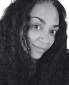 black and white headshot of Eman Abdalla with long curly black hair